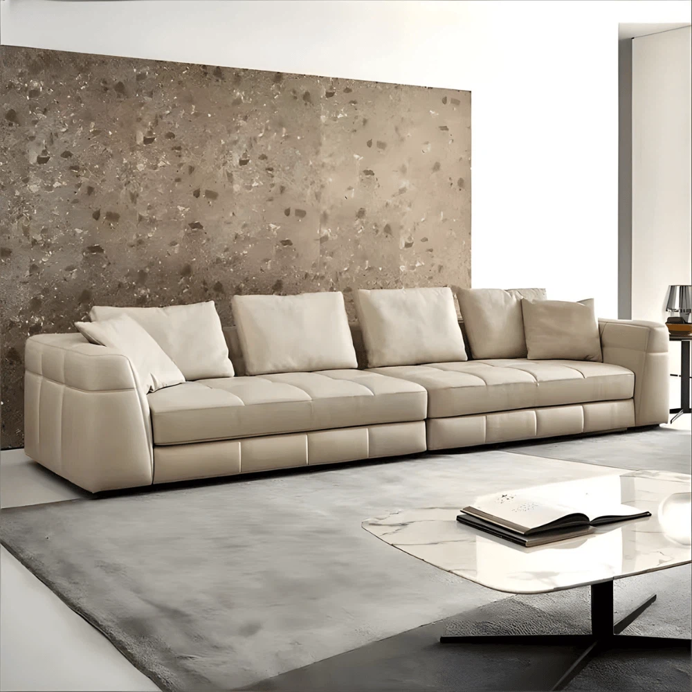Contemporary leather sectional sofa in a bright living room with minimalist furniture decor. Contemporary leather sectional sofa in a bright living room with minimalist furniture decor.